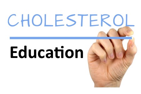 A person's hand writing out Cholesterol Education in blue ink.
